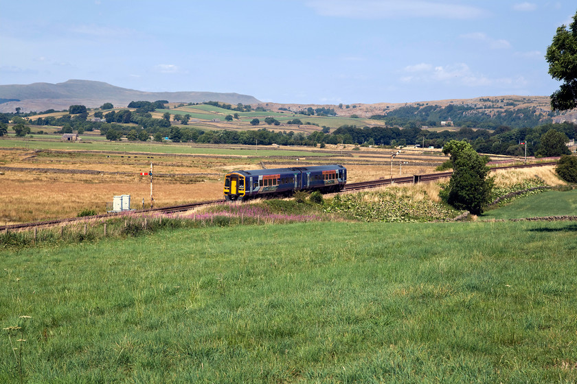 158784, NT 10.49 Carlisle-Leeds (2H89, 6L), Settle Junction SD813606 
 As we were driving down the A65 just south of Settle we noticed that the up line was pegged at Settle Junction. We also spotted a half decent spot and a place to pull off the road and park safely. After a short wait, 158784 arrived with the 10.49 Carlisle to Leeds. Set against a lovely backdrop dominated by the flat topped peak of Ingleborough at 2 372 feet the scenery is superb. Off course, Ingleborough is better known to us in the railway fraternity as 44007 (D7) and, more recently, as 60022. The eagle eyed almost you will have spotted that in this picture are no fewer than four home signals all controlled by Settle Junction signal box some short distance away. 
 Keywords: 158784 2H89 Settle Junction SD813606