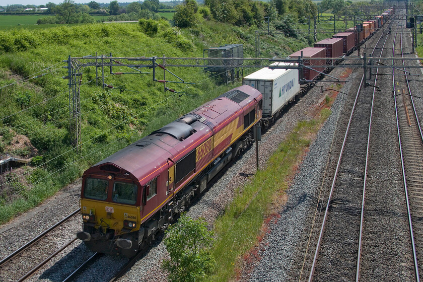 66080, 05.06 Southampton Western Docks-Masborough 4E94 Victoria bridge 
 Former EWS liveried (but DB branded) 66s are getting noticeably fewer now, and so they should sixteen years after the fright operator ceased to be! 66080 leads the diverted 4E94 05.06 Southampton to Masborough intermodal working. Once the Nuneham bridge is reopened in the coming few weeks, interesting workings such as this will revert to their regular route via Oxford taking them away from the busy WCML. 
 Keywords: 6608005.06 Southampton Western Docks-Masborough 4E94 Victoria Bridge EWS DB Freightliner