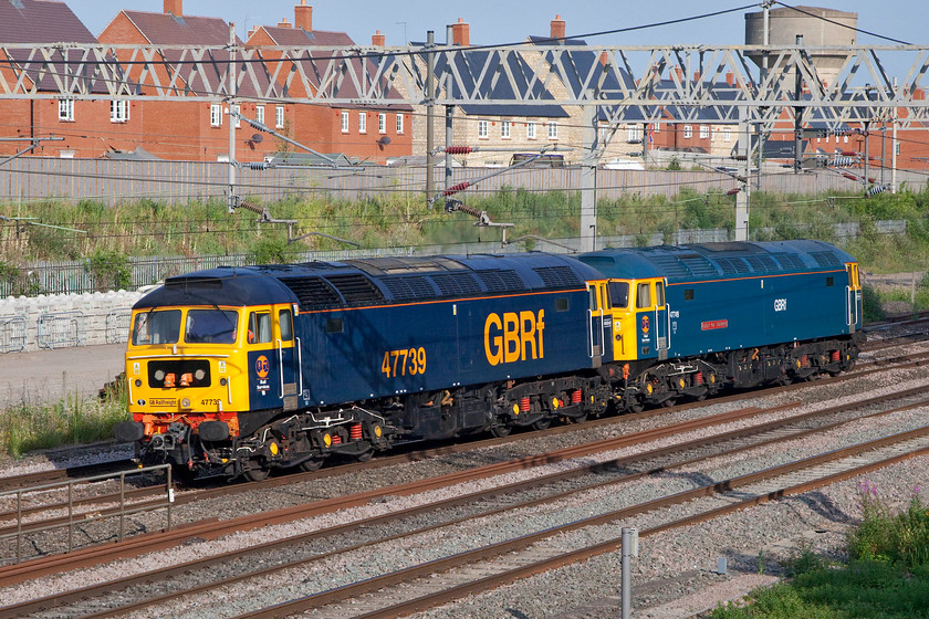 47739 & 47749, 18.30 Wolverton centre sidings-Rugby (0D21, 2L), site of Roade station 
 Looking absolutely superb, 47739 and 47749 'City of Truro' pass light engine through Roade on a lovely summer evening. They are making the relatively short trip from Wolverton Works to Rugby as 0D21 for overnight stabling. Earlier in the day, they had hauled a GA Class 720 from Derby Litchurch Lane to the works and the following day they would head south to Ilford to collect a Class 360 that is destined for further use on the newly electrified MML. 
 Keywords: 47739 47749 18.30 Wolverton centre sidings-Rugby 0D21 site of Roade station GBRf City of Truro