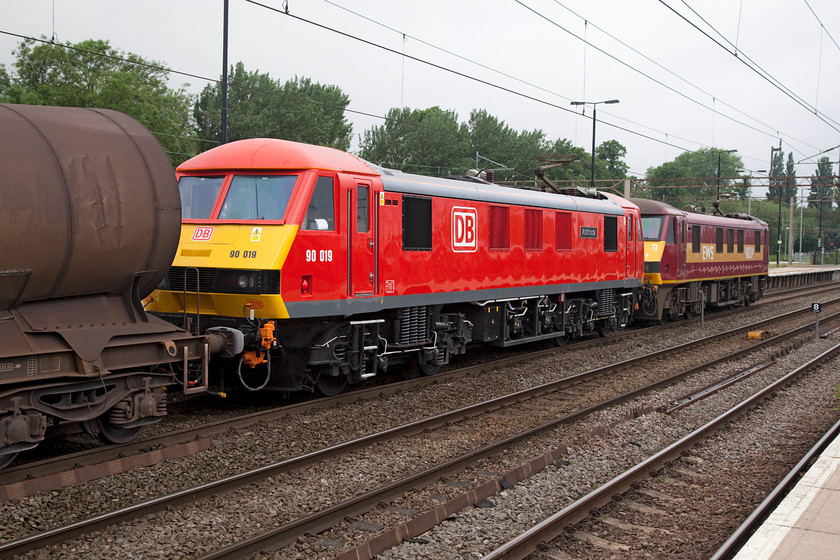 90019 & 90039, 02.32 Dollands Moor-Irvine paper mill (6S94), Northampton station 
 90019 'Multimodal' and 90039 draws the 02.32 Dollands Moor to Irvine paper mill china clay working through Northampton station. You could almost smell the fresh paint from 90019 resplendent in its new DB livery. Whilst this train is often double-headed, I did wonder if 90019 was on a proving run after have been to the workshops with 90039 as insurance? 
 Keywords: 90019 90039 02.32 Dollands Moor-Irvine paper mill 6S94 Northampton station