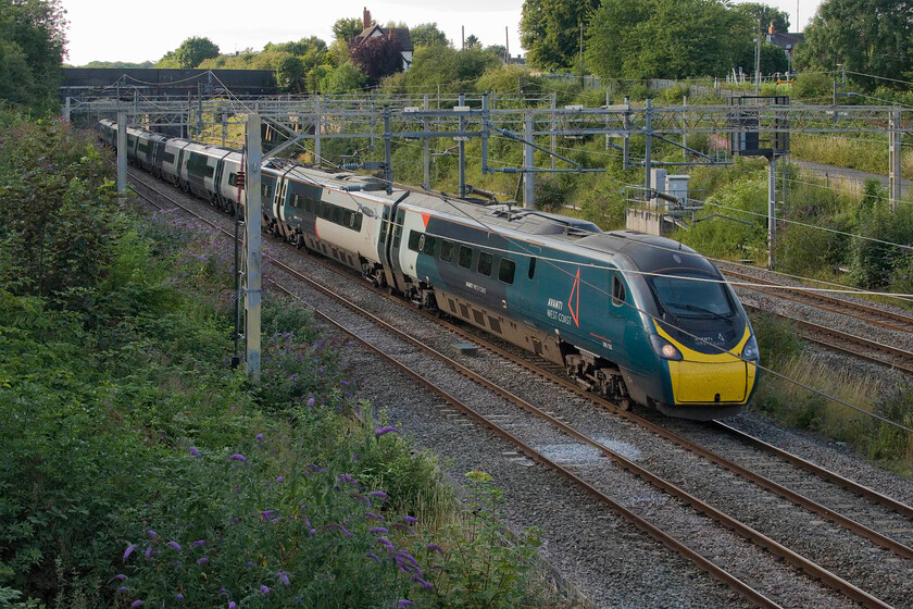 390046, VT 16.55 Manchester Piccadilly-London Euston (1A57, 1E), site of Roade station 
 The 1A57 16.55 Manchester to Euston Avanti service passes through Roade worked by 390046. After some really disappointing weather, this was the first day of what was to become some welcome nice and hot summer days. 
 Keywords: 390046 16.55 Manchester Piccadilly-London Euston 1A57 site of Roade station Avanti West Coast Pendolino