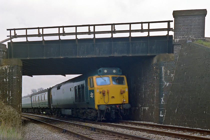 50022, unidentified down working, Westbury cut off (under Portsmouth line) ST855511 
 This is a picture that I am quite impressed with! The reason being that I have managed to 'freeze' 50022 on the Westbury cut-off avoiding line so successfully! This train will have been going at a fair rate of knots so how the Exa camera's maximum 1/150th sec. shutter speed has avoided blur is beyond me! The train is an unidentified down working passing under the Portsmouth line just south west of Westbury station. This is an 'unofficial spot' that I am not sure how we got to? Finally, there is a question as to this 50s identity. Whilst I have this down in my notes as 50022, this locomotive was supposed to have been named two days prior to this image being taken. Clearly, there is no nameplate on the side of the locomotive but, interestingly, the BR double arrow logo has been moved to the cab end, a procedure that was undertaken to accommodate the nameplates on the centre bodyside. 
 Keywords: 50022 down working Westbury cut off under Portsmouth line ST855511