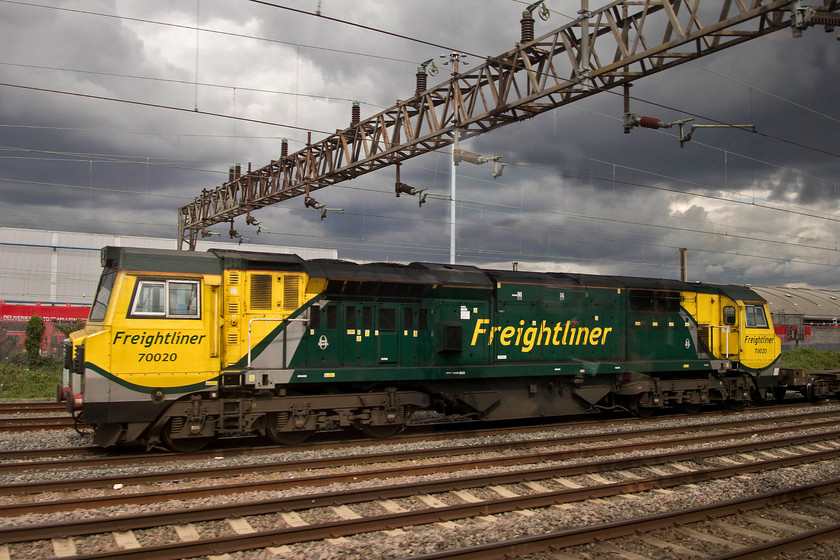 70020, 11.13 Felixstowe North-Trafford Park (4M87), Wembley yard 
 Under threatening skies in Wembley Yard, 70020 pauses waiting for its path to continue northwards with the 11.13 Felixstowe North to Trafford Park Freightliner. This class 70 was photographic cop for me so I was pleased to see it and get a shot under such a dramatic sky even if it is taken from a passing train. 
 Keywords: 70020 11.13 Felixstowe North-Trafford Park 4M87 Wembley yard