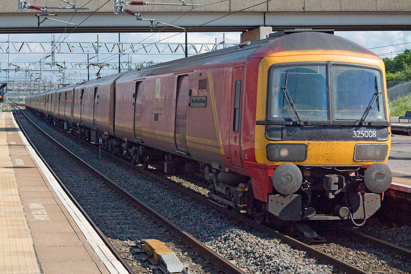 323008, 16.22 Willesden-Sheildmuir (1S96), Milton Keynes Central station 
 Despite TPOs having being consigned to history back in January 2004, pre-sorted mail is still moved in these custom built class 325 EMUs. 325008 'Peter Howarth CBE' leads two other units making it a twelve car formation past Milton Keynes as the 16.22 Willesden to Sheildmuir. 
 Keywords: 323008 16.22 Willesden-Sheildmuir 1S96 Milton Keynes Central station