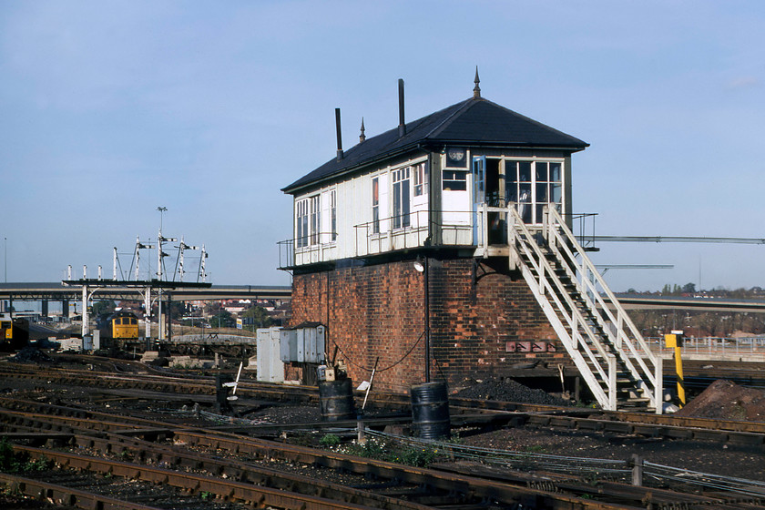 Brent Yard no. 2 signal box (Mid, 1892) 
 Quite how Graham and I had the gall to wander into Brent Yard and take photographs such as this is beyond me! However, we did seem to walk about the yard with impunity for the next few hours. Against a glorious November sky, the superb Brent Yard no. 1 signal box is viewed looking in virtually original condition with its finials and its twin stove pipes. Notice the pile of coal and the shovel under the steps ready to keep the fires burning inside the box during these chilly winter shifts. I can find out precious little about this box apart from it being of obvious Midland construction dating from 1892. If anybody can furnish me with any other information I would be grateful. 
 Keywords: Brent Yard no. 2 signal box