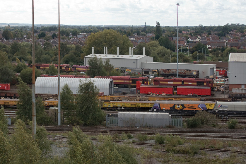 60008, 60075 & 60004, stored, Toton yard 
 A number of forlorn-looking Class 60s at Toton are seen from the bank. Of those that I could identify are 60008 'Sir William McAlpine' still wearing its nameplates, 60075 formally 'Liathach' and 60004 formally 'Lochnagar'. This is an interesting view and one that is virtually identical to the image that I took of 44007 (ex D7 'Ingleborough') back in October 1979, see.... https://www.ontheupfast.com/p/21936chg/27432132604/x44007-freight-toton-yard. Whilst it is hard to believe that the view is the same close examination of the two images reveals the white lock gates on the Erewash Canal in the middle distance to the right as reference points. Further scrutiny reveals that some of the houses are still the same, those now not hidden by trees that is! 
 Keywords: 60008 Sir William McAlpine 60075 Liathach 60004 Lochnagar stored Toton yard