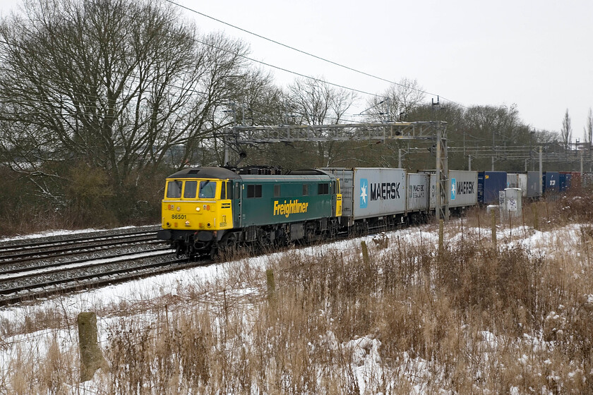 86501, 05.03 Trafford Park-Felixstowe North (4L97), Roade 
 Following some snowfall the previous night 86501 hauls the 4L97 05.03 Trafford Park to Felixstowe Freightliner past Roade. This particular member of the class was a bit of a testbed in terms of freight work conversion with the number actually carried by two 86s. In this final form, it has also been prone to fire with two events causing significant damage to it with the latest in 2009 near here at Bletchley. 
 Keywords: 86501 05.03 Trafford Park-Felixstowe North 4L97 Roade Freightliner