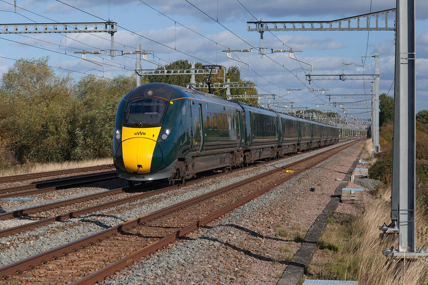 802104 14.32 London Paddington-Weston-Super-Mare (1C18, RT), Grove foot crossing SU393911 
 Reverting back to my standard mid-range zoom on the Canon full-frame presents a more conventional photograph at Grove. A few minutes after the previous IET headed westwards 802104 approaches the foot crossing near Grove on Oxfordshire. Standing in this position looks as though I may be exposed but I was in a safe position inside a timber corral that would cause no concern to the driver on the fast-approaching train. 
 Keywords: 802104 14.32 London Paddington-Weston-Super-Mare 1C18 Grove foot crossing SU393911 GWR IET