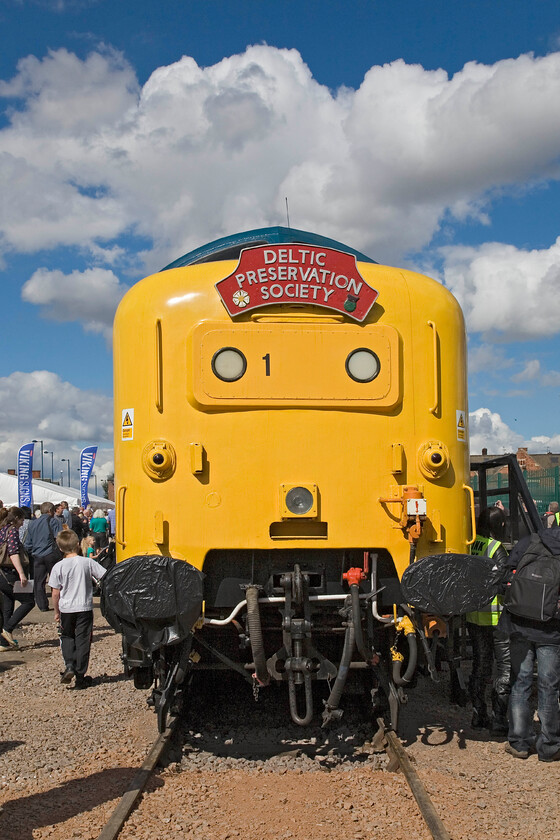 55019, on display, Mallard 75 celebrations, Grantham Yard 
 From many angles, the bulk and size of a Deltic is impressive and no more so than from the front. The huge nose cone of 55019 'Royal Highland Fusilier' is seen in a small yard to the eastern side of Grantham station on display as part of the Mallard 75 celebrations. It is proudly wearing a Deltic Preservation Society who own the locomotive that is, unfortunately not mainline registered at present. I am not sure as to what the large number one is applied to the marker lights panel. 
 Keywords: 55019 Mallard 75 celebrations Grantham Yard Deltic Royal Highland Fusilier