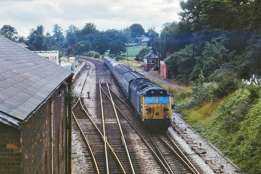 50020, 15.15 Plymouth-Manchester, Wellington 
 The next signal box down from Taunton's Silk Mill was Wellington. 50020 'Revenge' is seen rushing down the gradient from Whiteball Summit with the 15.15 Plymouth to Manchester Piccadilly. Wellington Signal box can be seen on the remains of the disused up station platform. This station closed on 5th October 1964 with active and continuing discussions regarding its re-opening. However, as we all know, these discussions can take many years to come to fruition and often include absolutely stunning costings from Network Rail. To me, by producing these ridiculous costings, it's almost as if they are not in favour of re-openings, seeing them as too much 'bother'? 
 Keywords: 50020 15.15 Plymouth-Manchester Wellington