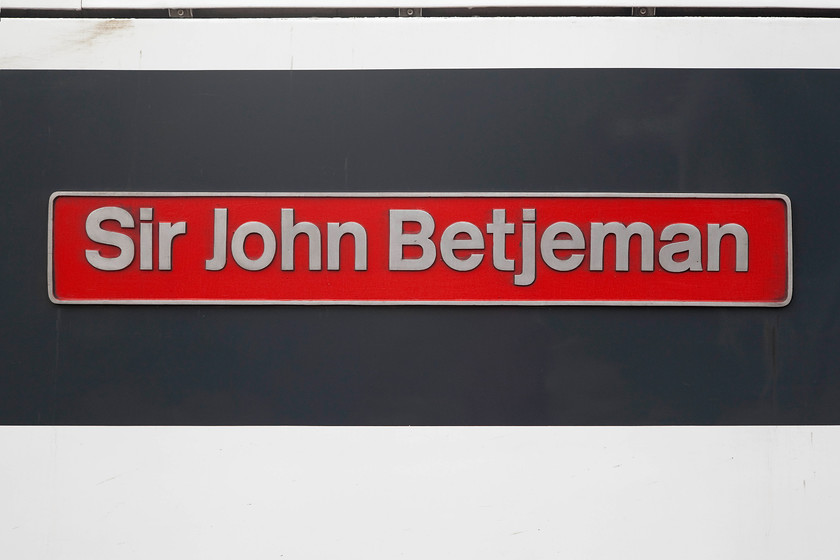 Nameplate, 90007, LE 12.00 Norwich-London Liverpool Street (1P35), Norwich station 
 The nameplate of 900007 'Sir John Betjeman' looks good on the side of the locomotive attached to the grey section of the revised Greater Anglia livery. 
 Keywords: Nameplate 90007 12.00 Norwich-London Liverpool Street 1P35 Norwich station