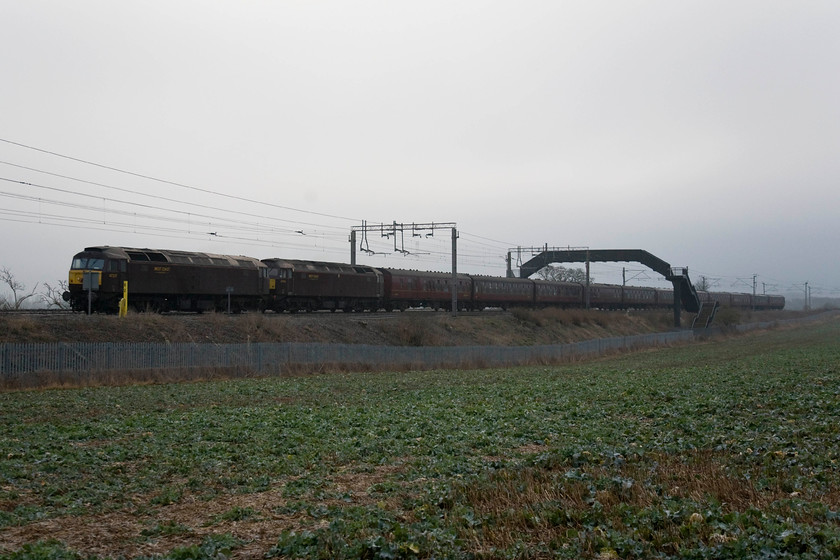 47237 & 47744, outward leg of The Winter Cumbrian Mountain Express 2 , 07.09 London-Euston-Carnforth (1Z66), Blisworth 
 A drab pair if WCR locomotives and stock, a dark winter's morning and poor positioning of the train have conspired to help create what is possibly one of the worst photographs that I have taken in recent years! So, for that reason, I am proudly presenting it! 47237 and 47744 lead the outward leg of The Cumbrian Mountain Express that had left London about an hour earlier. The 47s led the train to Carnforth where 46233 'Duchess of Sutherland' took over for the trip over Shap to Carlisle. The dismal scene is taken at Blisworth on the Weedon loop of the southern WCML; let's not dwell any further on this image! 
 Keywords: 47237 47744 The Winter Cumbrian Mountain Express 2 07.09 London-Euston-Carnforth 1Z66 Blisworth