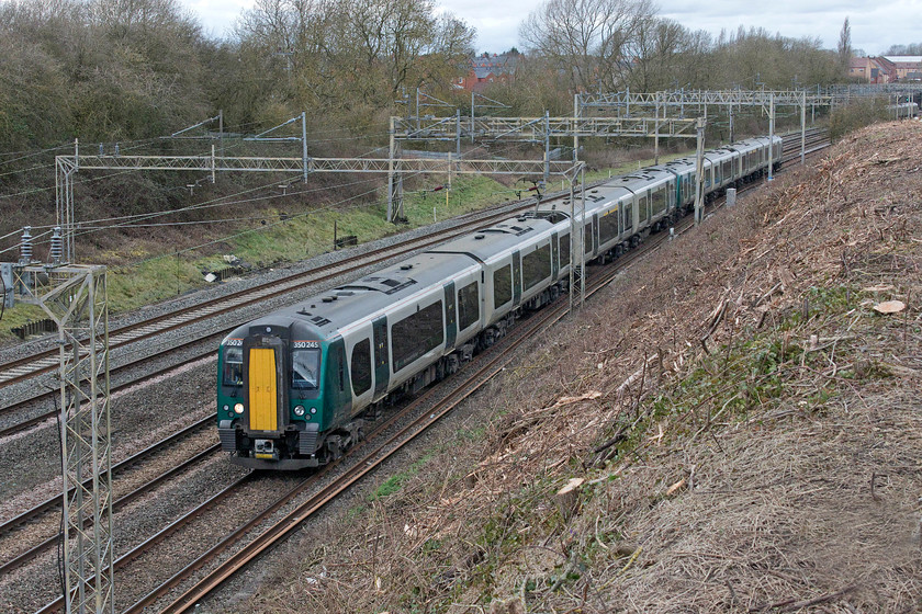 350245 & 350252, NT 13.13 Rugeley Trent Valley-London Euston (1Y26, 1L), Ashton Road bridge 
 With the village of Roade in the background, 350245 and 350252 head south with the 13.13 Rugeley Trent Valley to Euston service. I am standing on a section of Armco that protects the approach to Ashton Road bridge, a picture that would not be possible a month or so ago as Network Rail have just completely cleared the embankment in preparation for stabilisation work. 
 Keywords: 350245 350252 13.13 Rugeley Trent Valley-London Euston 1Y26 Ashton Road bridge London North Western Railway Desiro