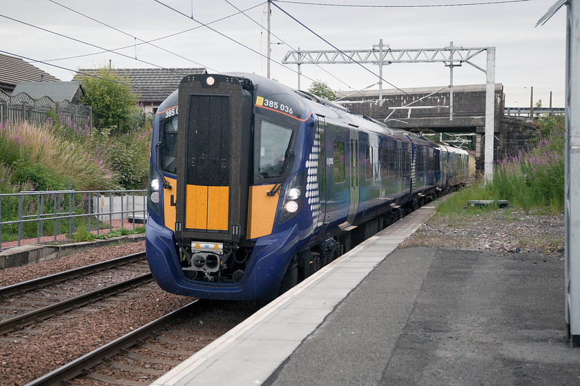 385036, SR 14.56 Edinburgh Waverley-Glasgow Central (1Y87, RT), Hartwood station 
 385036 whisks through Hartwood station with the 14.56 Edinburgh to Glasgow Central service. Hartwood is situated in the pleasant countryside of north Lanarkshire. It has not enjoyed buoyant passenger numbers, particularly since the large psychiatric hospital, in whose grounds it is located, closed. The station has been re-built with the line electrified and a full service commencing just three months prior to this photograph being taken. 
 Keywords: 385036 14.56 Edinburgh Waverley-Glasgow Central 1Y87 Hartwood station