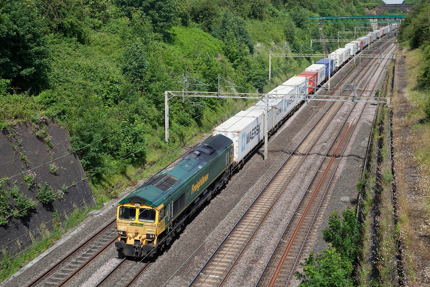 66411, 08.25 Crewe Basford Hall-Felixstowe North (4L93), Roade Cutting 
 Control allowed this 70mph restricted Freightliner working to use the up fast Weedon loop line as the usual route between Rugby and Northampton was closed due to an 'emergency incident'. 66411 leads the 4L93 08.25 Crewe Basford Hall to Felixstowe Freightliner through Roade Cutting. Ironically, whilst most of the passenger workings experienced heavy delays, the freights did not do too badly, having so much slack built into their paths! 
 Keywords: 66411 08.25 Crewe Basford Hall-Felixstowe North 4L93 Roade Cutting