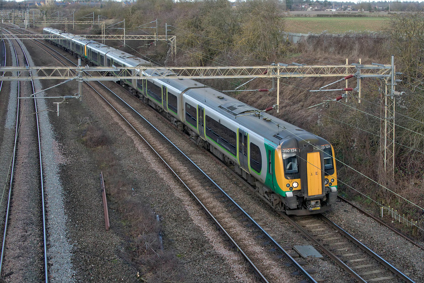 350124 & 350111, LN 09.05 Liverpool Lime Street-London Euston (2Y06, 2L), Victoria bridge 
 350124 and 350111 work the 09.05 Liverpool Lime Street to Euston service past Victoria bridge just south of my home village of Roade, indeed, my family home is in view to the right-hand side of the image. Having started off a bright and clear Christmas Eve, the clouds had now gathered and in the absence of any freight workings, I decided to head for home. 
 Keywords: 350124 350111 09.05 Liverpool Lime Street-London Euston 2Y06 Victoria bridge London NorthWestern Desiro