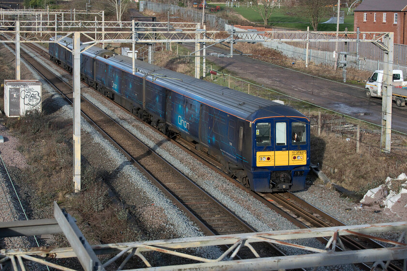 319373, 05.34 Shieldmuir-Willesden PRDC (3Q41, 6E), site of Roade station 
 On the day when I was out, as was the sun, Orion's 05.34 Shieldmuir to Willesden 3Q41 service was composed of one unit and was not locomotive-hauled as had been the case for the last week or so! 319373 passes through Roade taken from the village's Gravel bridge located at the site of the former station. 
 Keywords: 319373 05.34 Shieldmuir-Willesden PRDC 3Q41 site of Roade station Orion Logistics