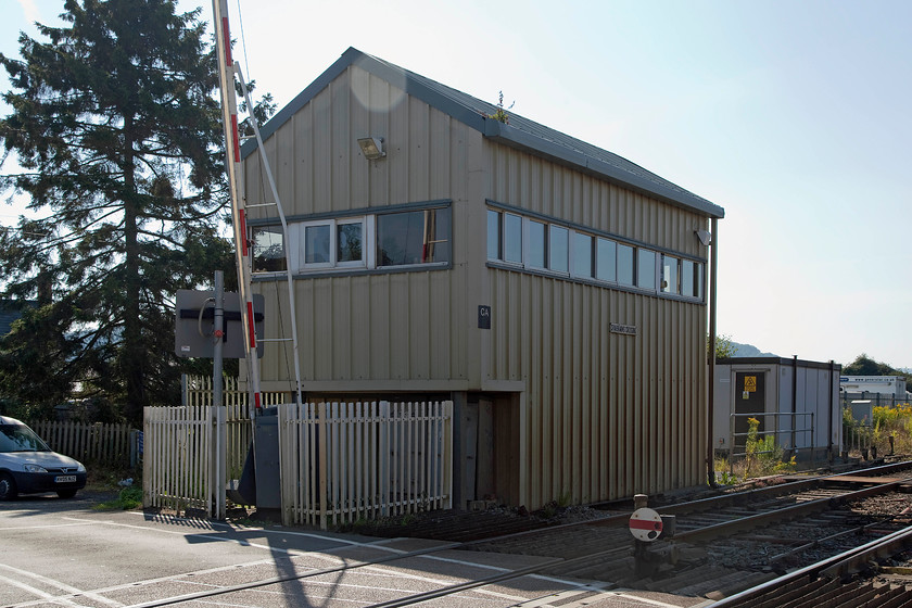 Craven Arms Crossing signal box (Re-built, Railtrack, 2000) 
 Railtrack is not well remembered in the annals of railway history for a number of reasons, not least is this structure! It was built around the original GW 1947 box in 2000 encasing the wooden structure that was beyond repair. During the summer of 2000, the frame and cladding were constructed and finally, the old box was dismantled from within. The original frame, possibly dating from 1931, and other equipment were retained. Just coming into the shot on the left is my Combo van. 
 Keywords: Craven Arms Crossing signal box