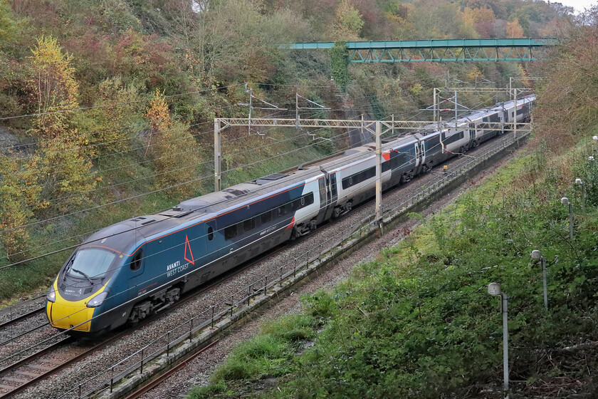 390045, VT 10.01 Preston-London Euston (1A17, 4E), Roade bypass bridge 
 Taken from beneath the new A508 Roade bypass bridge that spans Roade cutting 390045 'Birmingham Pride' heads south working the 10.01 Preston to Euston Avanti service. Notice the movement sensors to the right of the image that are linked to a device that will inform some computer somewhere or other of changes to the profile of the embankment. 
 Keywords: 390045 10.01 Preston-London Euston 1A17 Roade bypass bridge AWC Avanti West Cast Pendolino Birmingham Pride