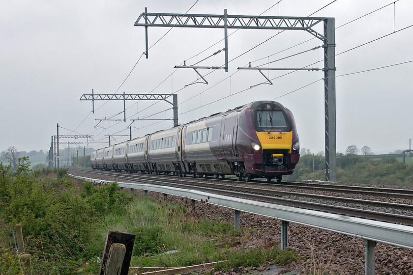 222006, EM 09.12 Nottingham-London St. Pancras (1B26, RT), Wymington SP946644 
 A dramatic low angled view of 222006 'The Carbon Cutter' as it climbs towards Sharnbrook summit on the up fast line working the 09.12 Nottingham to St. Pancras service. In the background, the wiring of the recently re-doubled slow lines can be seen. For a short distance, they diverge from the fast lines not climbing quite as high at Shrarnbrook summit but going through the one thousand eight hundred and seventy-yard long tunnel. 
 Keywords: 222006 09.12 Nottingham-London St. Pancras 1B26 Wymington SP946644 East Midlands Railway EMR Meridian The Carbon Cutter