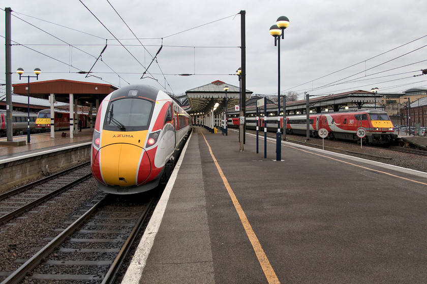 82219, GR 14.30 London King`s Cross-Newcastle (Cancelled from York) (1N21, 7L), 800107, 17.11 York-Doncaster ECS (5Q24) & 82229, GR 14.30 Edinburgh-London King`s Cross (1E19, 3L), York station 
 In the gathering gloom, wind and rain at York station, a trio of LNER trains are seen brightening up the view! To the left 82219 sits at the back of the 14.30 King's Cross to Newcastle. This train was cancelled here at York along with many other northbound services due to a line closure at Chester-Le-Street. In the centre is 800107 waiting to work the 5Q24 crew training run to Doncaster with no less than four people in the cab! To the right, 82229 is leading the 14.30 Edinburgh to King's Cross. With the class 91/82 Mk.IV sets still dominating ECML services, things about to change as the the class 800 Azumas enter service in the coming weeks. 
 Keywords: 82219 14.30 London King`s Cross-Newcastle 1N21 800107 17.11 York-Doncaster ECS 5Q24 82229 14.30 Edinburgh-London King`s Cross 1E19 York station