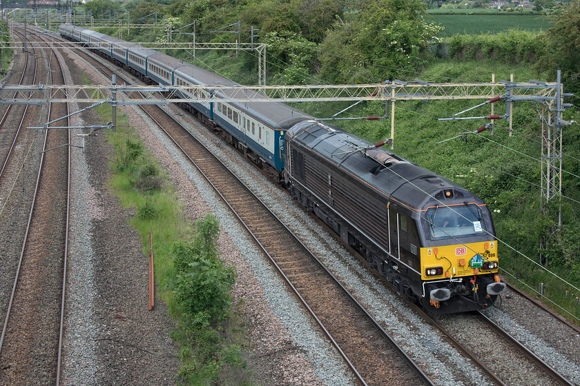 67006, 09.22 Huddersfield-Wembley Central (1Z68, 3L), Victoria bridge 
 67006 'Royal Sovereign' leads a superb uniform set of retro liveried BR stock past Victora bridge just south of Roade. It was leading the 1Z86 09.22 Huddersfield to Wembley Central footex carrying football supporters to the capital for the 2021/22 Championship play-off final with Nottingham Forest. Unfortunately, the fans on-board the train were to be disappointed with them losing 1-0 to Forest, unlike the previous day when their rugby league team were triumphant beating Wigan Warriors 16-14 in the season-ending Challenge Cup final. 
 Keywords: 67006 09.22 Huddersfield-Wembley Central 1Z68 Victoria bridge Royal Sovereign