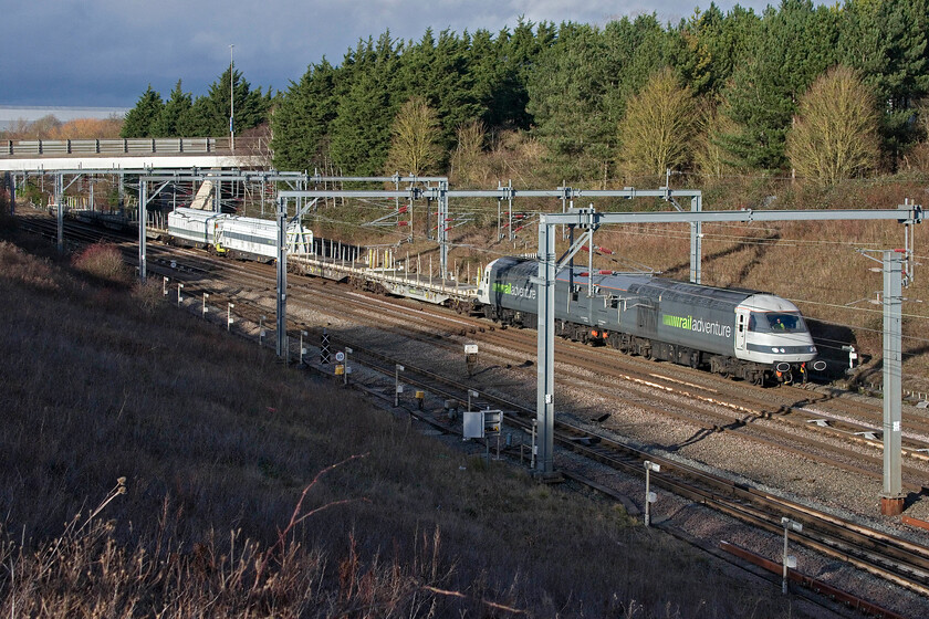 43468 & 43465, 10.24 Kidderminster SVR-Wembley Yard (6Z43, 16E), Loughton Redway bridge, Milton Keynes 
 Superpower for a barrier train! 43468 and 43465 lead the 10.24 Kidderminster SVR to Wembley Yard barrier train running as 6Z43 through Milton Keynes just north of the station. The train was being positioned for a future new stock move of some kind, possibly of a new Merseyrail Class 777 unit. I cannot quite get used to the new look of the HST power cars devoid of their yellow hi-viz front panel. With new lighting fitted at the front, they are exempt from having the yellow panel. 
 Keywords: 43468 43465, 10.24 Kidderminster SVR-Wembley Yard 6Z43 Loughton Redway bridge Milton Keynes Rail Adventure HST