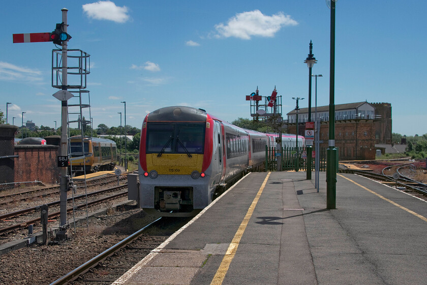 175109, AW 11.31 Manchester Piccadilly-Carmarthen (cancelled from Swansea) (1V40, 15L), Shrewsbury station 
 Forgive this scene looking into the summer sun but I could not resist a second photograph of the 11.31 Manchester to Carmarthen service this time leaving Shrewsbury station to the south. The background is dominated by the incredible Severn Bridge Junction signal box the future of which has just been assured by Network Rail (soon to become GBR) as they have just completed a 250,000 refurbishment of the structure in anticipation of it being in use for another thirty years! The train is passing the up starter bracket that supports two centre pivoted wooden arms. These are unique now by virtue of their spectacles being located to the left of the pivot points. Until the mid-1970s there was also a couple of calling on arms with describers behind the spectacles mounted just below the present arms. Notice the SBJ5 signal that is the up main home for Severn Bridge Junction. 
 Keywords: 175109 11.31 Manchester Piccadilly-Carmarthen cancelled from Swansea 1V40 Shrewsbury station Transport for Wales Rail Services