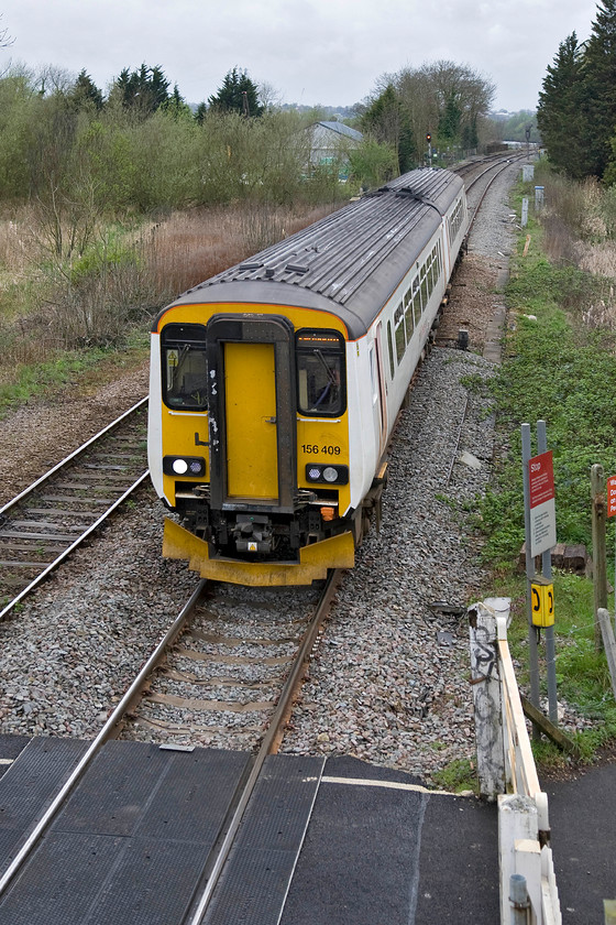 156409, LE 12.36 Norwich-Great Yarmouth (2P20), Whitlingham Lane crossing TG266083 
 Seen a short time earlier and photographed at the level crossing just visible in the background. Such is the intensive use that the Greater Anglia units are put to it is in use again heading back to Great Yarmouth having left Norwich a few minutes previously at 12.36. I am standing on a vintage rickety iron footbridge that stands at the end of Whitlingham Lane that leads to a riverside footpath. 
 Keywords: 156409 12.36 Norwich-Great Yarmouth 2P20 Whitlingham Lane crossing TG266083 Abellio Greater Anglia