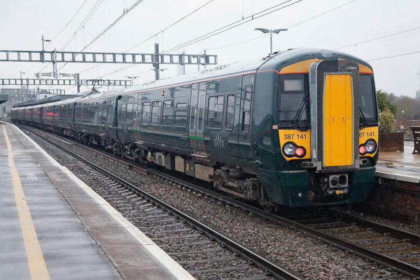 387141, GW 16.03 Didcot Parkway-London Paddington (1P35, RT), Didcot Parkway station. 
 This scene belies what appears to be a perfectly normal situation. 387141 leaves Didcot with the 16.03 to London Paddington. These Thames services all terminate at and start from Didcot rather than Oxford as should be the situation. But, following the decision not to continue the electrification to Oxford some 10 miles north, these very expensively procured units now only go as far as Didcot. The Oxford passengers have to go through the farcical process of changing to an old diesel unit to complete (or to start) their journeys. It begs the question, is this the way a modern railway should be operating? I can't help feeling that there was a better service in NSE days with 50s hauling a pretty intensive set of return diagrams that got the job done. 
 Keywords: 387141 1P35 Didcot Parkway station.