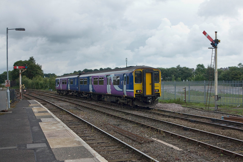 150210, NT 13.29 Buxton-Manchester Piccadilly (2H01), Buxton station 
 150210 leaves Buxton station with the 13.29 to Manchester Piccadilly. It has just passed one of Buxton's two remaining starter signals that are controlled by the LNWR 1894 signal box a short distance away to the left just out of shot in this image. 
 Keywords: 150210 13.29 Buxton-Manchester Piccadilly 2H01 Buxton station