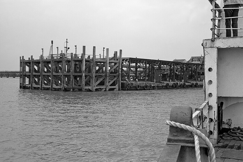 New Holland Pier from MV Farringford 
 As MV Farringford commences the 16.50 sailing to Hull Corporation Pier New Holland Pier is seen in all its rickety glory! Whilst the timber piles nearest to the camera are fixed into the bed of the Humber estuary the centre section is a floating pontoon that rises and falls with the ebb and flow of the tide. Whilst the ferry service from the pier has long ceased the pier is still very much in use now as a grain loading facility with fairly large coasters able to berth at the pier. 
 Keywords: New Holland Pier from MV Farringford Sealink