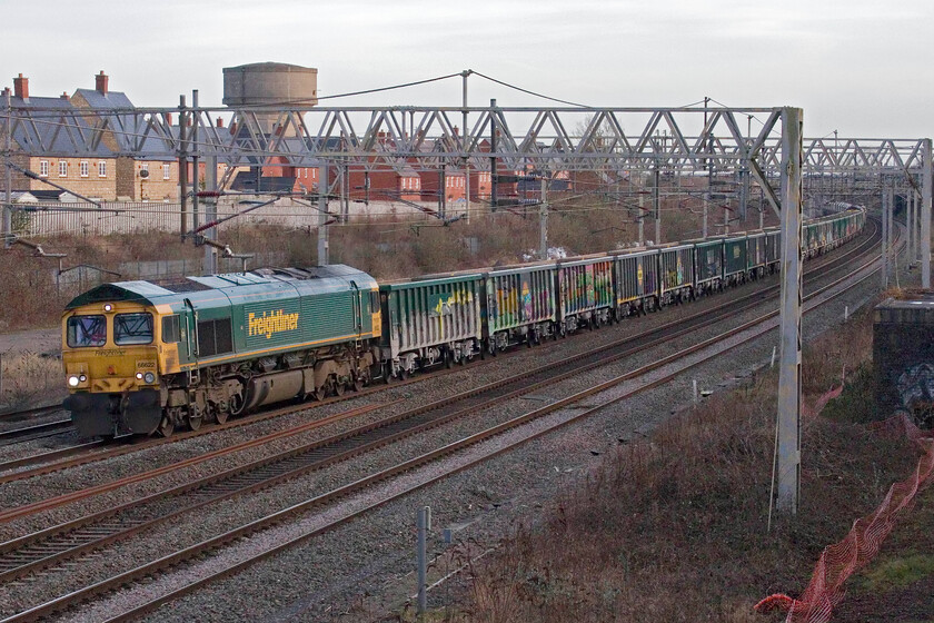 66622 & 66413, 13.14 Wembley Reception-Tunstead Sidings (6H50, 102L), site of Roade station 
 I was aware that the regular 13.14 Wembley Yard to Tunstead Siding stone empties was running very late but was unaware as to the cause. When I pressed the camera shutter framing 66622 leading the train I did not spot another locomotive in the consist as seen in this image. Not only was 66413 'Lest We Forget' being towed along but also its train! 
 Keywords: 66622 66413 13.14 Wembley Reception-Tunstead Sidings 6H50 site of Roade station Lest we Forget