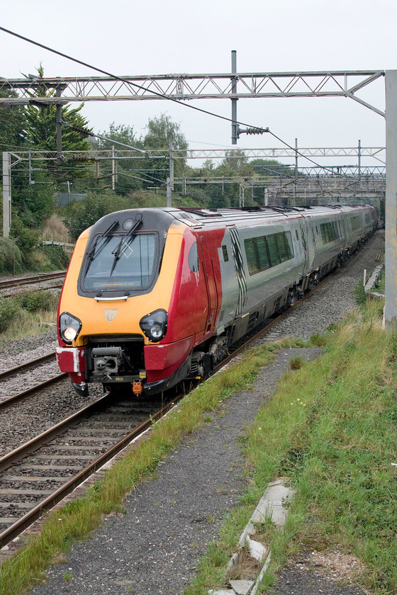 221103 & 221109, VT 12.23 London Euston-Birmingham New Street (9G20, 1L), site of Castlethorpe station 
 Get them while you can! It was presumed that the former Virgin Voyagers would soldier on in their former operator's livery for some time until their new operator would dispose of them in two years time. However, with them looking increasingly tatty and a little out of place, Avanti has just announced that they will be 'refreshing' them over the coming few months, see.... https://newsdesk.avantiwestcoast.co.uk/news/voyager-fleet-upgraded-by-avanti-west-coast Passing Castlethorpe working the 12.23 Euston to Birmingham New Street 221103 (and 221109) are seen. 
 Keywords: 221103 221109 12.23 London Euston-Birmingham New Street 9G20 site of Castlethorpe stationAvanti West Coast Voyager