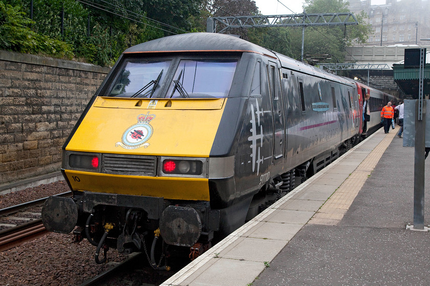 91110, GR 13.30 London King`s Cross-Edinburgh (1S19), Edinburgh Waverley station 
 91110 'Battle of Britain Memorial Flight' has just arrived at Edinburgh with the 13.30 from King's Cross and the driver has already switched his tail lights on for a return journey either to Craigentinny or back to London. The livery of this member of the class 91 fleet looks very impressive complete with its superb nameplate and crest. 
 Keywords: 91110 13.30 London King`s Cross-Edinburgh 1S19 Edinburgh Waverley station