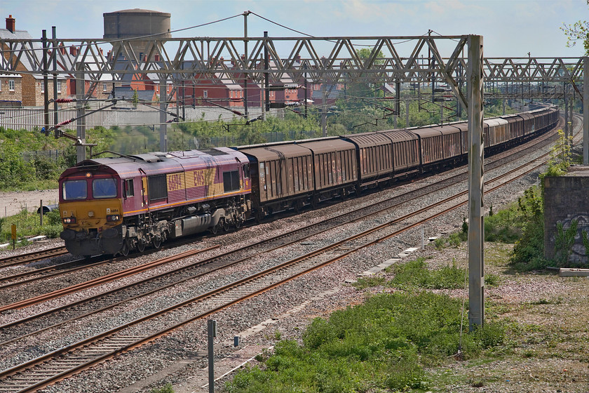 66194, 07.05 Dollands Moor-DIRFT (6M45, 13L), site of Roade station 
 66194 brings the 07.05 Dollands Moor to Daventry past the site of Roade station. This train, full of bottled water imported through the tunnel, and its balancing empty return working are the most regular and dependable freight workings on this section of the WCML being a seven days per week operation and running at about the same times for a number of years. 
 Keywords: 66194 07.05 Dollands Moor-DIRFT 6M45 site of Roade station EWS