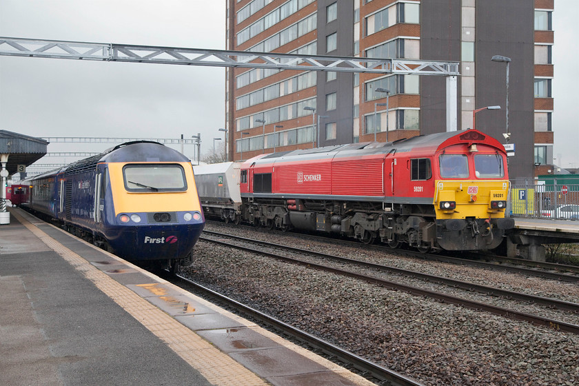 43153, GW 13.01 WSM-London Paddington (1A19, RT) & 59201, 11.35 Merehead-Wootton Bassett (7B12), Swindon station 
 43153 waits to leave Swindon station with the 13.01 Weston-super-Mare-London Paddington whilst 59201 brings the 11.35 Merehead-Wootton Bassett 7B12 stone train through platform 4. 59201 was introduced in April 1995 as part of a third and final batch ordered by National Power and EWS. 
 Keywords: 43153 1A19 59201 1135 Merehead to Wootton Bassett 7B12 Swindon station