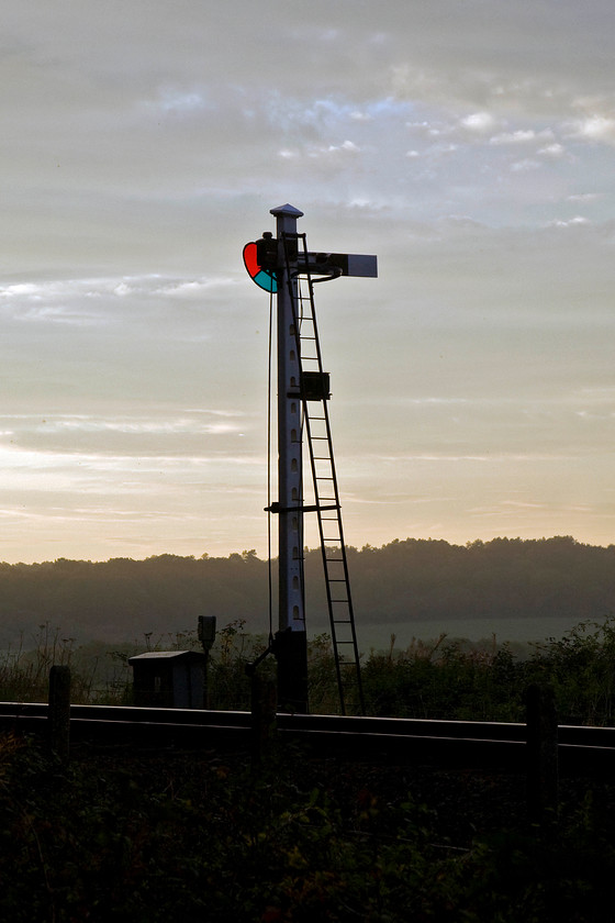 Home signal, Weybourne 
 Weybourne's home signal is nicely silhouetted against the last of the afternoon sunshine as the sun sets. The lenses of the Great Eastern origin signal, complete with slotted post add a dash of colour to the photograph. I toyed with the idea of desaturating the image just leaving the green and red of the lenses but it it looked a little pass preferring the natural look. 
 Keywords: Home signal Weybourne