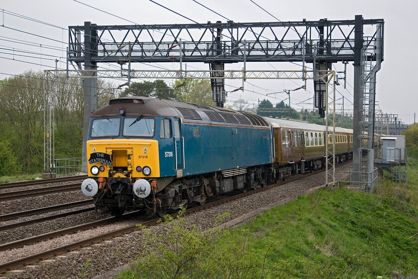 57316, outward leg of The Golden Arrow Statesman, 06.52 Birmingham International-Canterbury (1Z77, 5L), Roade Hill 
 Statesman Rail's Golden Arrow Statesman stretches its legs as it heads south between Northampton and Milton Keynes near the village of Ashton. For this first leg, running as 1Z77, from Birmingham International to Acton lane 57316 is leading with 57313 out of sight on the rear. The second leg from Acton Lane to Canterbury was to be hauled by 34067 'Tangmere'. Both the Class 57s were photographed on railtour duties last weekend in London, see.... https://www.ontheupfast.com/p/21936chg/30058169891/x57313-channel-coast-express-06-53 and... https://www.ontheupfast.com/p/21936chg/30058169893/x57316-channel-coast-express-06-53 
 Keywords: 57316 The Golden Arrow Statesman 06.52 Birmingham International-Canterbury 1Z77 Roade Hill Statesman rail