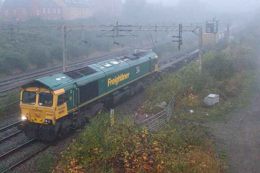 66593, 05.37 Crewe Basford Hall-London Gateway (4L52, 3E), site of Roade station 
 66593 '3MG Mersey Multimodal Gateway' passes through a very foggy Roade leading the 05.37 Crewe Basford Hall to London Gateway Freightliner. The increase in ambient lighting from the previous photograph is noticeable but with them only being taken five minutes apart. 
 Keywords: 66593 05.37 Crewe Basford Hall-London Gateway 4L52 site of Roade station Freightliner 3MG Mersey Multimodal Gateway