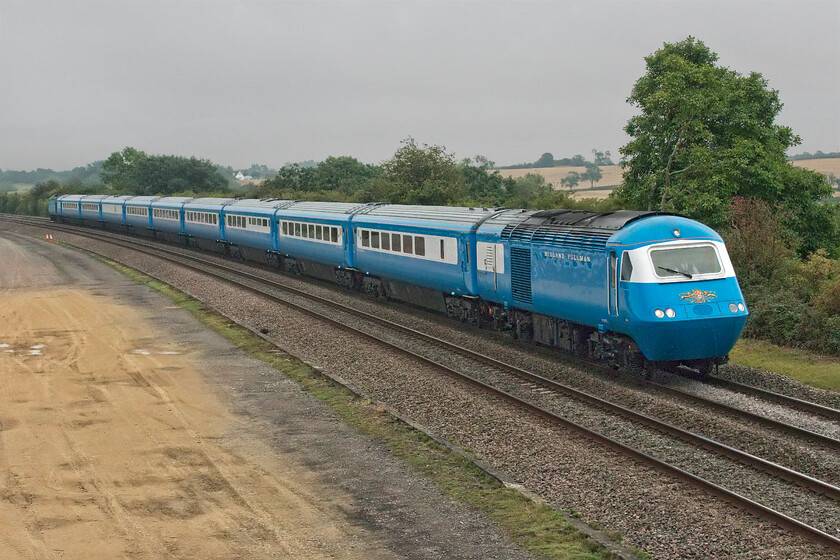 43055, outward leg The Settle & Carlisle Pullman, 06.18 London St. Pancras-Carlisle (1Z50, 1L), Braybrooke SP769849 
 With its Nanking blue paint scheme lifting the light on an otherwise grey and dull August morning the outward leg of Midland Pullman's 'The Settle and Carlisle Pullman' passes Braybrooke just south of its next stop at Market Harborough. The train is being led by 43055 a former East Midlands HST power car that is on its old stomping ground that it will have travelled on many times in its working career. At the rear of the train, that left St. Pancras at 06.18 heading for Carlisle, is a second former East Midlands power car 43046. 
 Keywords: 43055 The Settle & Carlisle Pullman, 06.18 London St. Pancras-Carlisle 1Z50 Braybrooke SP769849 Blue Pullman HST LSL