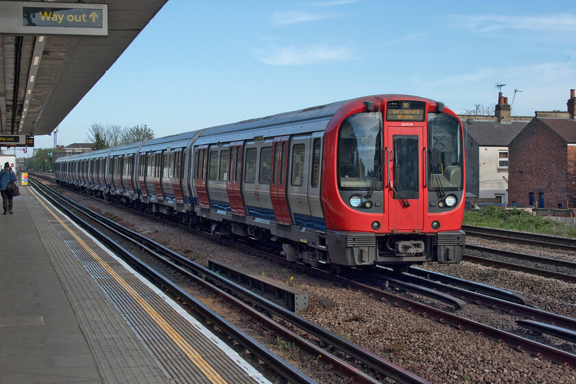 21032, Metropolitan train, Dollis Hill TfL station 
 Dating from 2010 the S8 stock has proved successful and offered a step change for London commuters replacing the A Stock on the Metropolitan Line. Taken from the platform of Dollis Hill station 21032 (A end leading) passes working a Metropolitan service from Aldgate to Amersham. 
 Keywords: 21032 Metropolitan train Dollis Hill TfL station