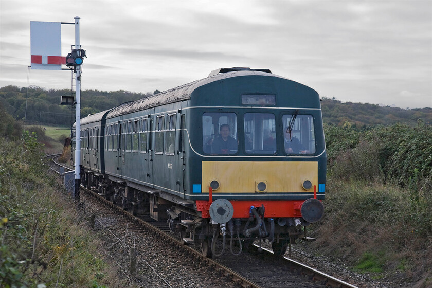 M56352 & M51192, 12.00 Holt-Sheringham, Weybourne TG122424 
 One of the North Norfolk Railway's resident Class 101 DMUs leaves Weybourne working the 12.00 Holt to Sheringham service. Luckily the sun has been partially covered by a veil of high cloud drifting in from the west otherwise this image would have been horribly backlit. Notice the Weybourne home signal with its sighting board installed for the reason that I have just described! 
 Keywords: M56352 M51192 12.00 Holt-Sheringham Weybourne TG122424