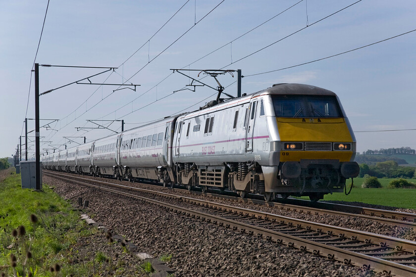 91109, GR 08.30 London King's Cross-Edinburgh Waverley (1F08), Frinkley Lane crossing SK906436 
 91109 'Sir Bobby Robson' leads the 1F08 08.30 King's Cross to Edinburgh past Frinkley Lane crossing between Grantham and Newark. This Class 91 was named in a ceremony at Newcastle station on 29.03.11 to commemorate the Newcastle lad and English footballer/manager's by his widow Elsie and Alan Shearer, patron of the Sir Bobby Robson Foundation. The naming of the loco. marked the resumption of a naming policy by the East Coast. 
 Keywords: 91109 08.30 London King's Cross-Edinburgh Waverley 1F08 Frinkley Lane crossing SK906436 East Coast Sir Bobby Robson