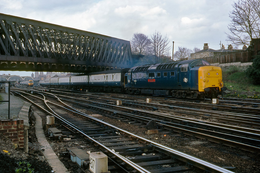 55002, 15.50 York-London King's Cross (1A26) & HST, Holgate Bridge 
 Having seen 55002 'The King's Own Yorkshire Light Infantry' enter York a little earlier it is now heading off south again leading the 1A26 15.50 York to King's Cross. It is passing under York's famous Holgate bridge that carries the one hundred and nine miles long A59 road into the city. The King's Cross train has just passed an HST that can be seen entering the station. Another photograph taken in a spot that is totally inaccessible today that if access was gained now would probably lead to an arrest! However, we never ventured onto the lines, we did not interfere with the running of the railway and did not put ourselves in any danger. Perhaps we had common sense then, something that people today do not have judging by the miles of pointless and obtrusive palisade fencing that lines our railways.

There is an audio recording of this event on my youtube channel, see.... https://youtu.be/UqCqHD4nUps 
 Keywords: 55002 15.50 York-London King's Cross 1A26 HST Holgate Bridge The King's Own Yorkshire Light Infantry