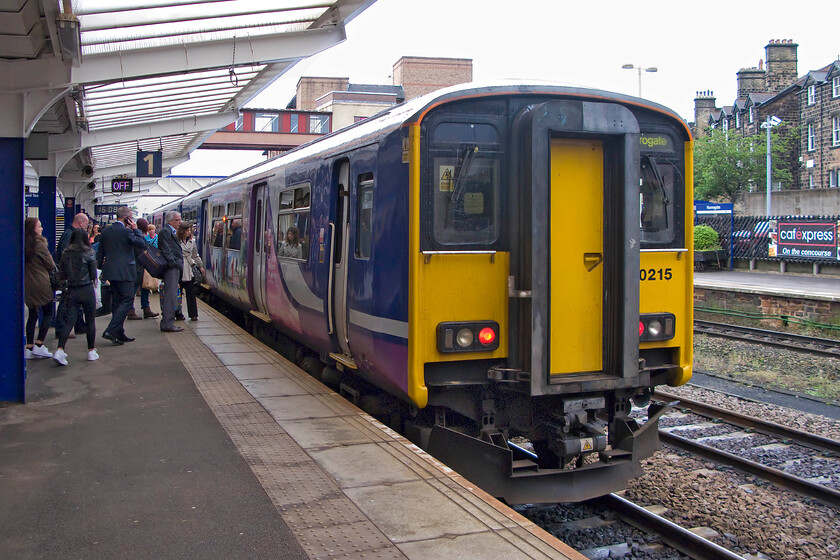 150215, NT 15.29 Leeds-York (2C42), Harrogate station 
 After a wet day spent largely dodging the rain in Harrogate my wife, son and I took the 15.29 Leeds to York Northern service back to York. The train was worked by 150215 that was already busy when it arrived here at Harrogate to be joined by other passengers meaning that t was standing room only for most of our journey. 
 Keywords: 150215 15.29 Leeds-York 2C42 Harrogate station Northern