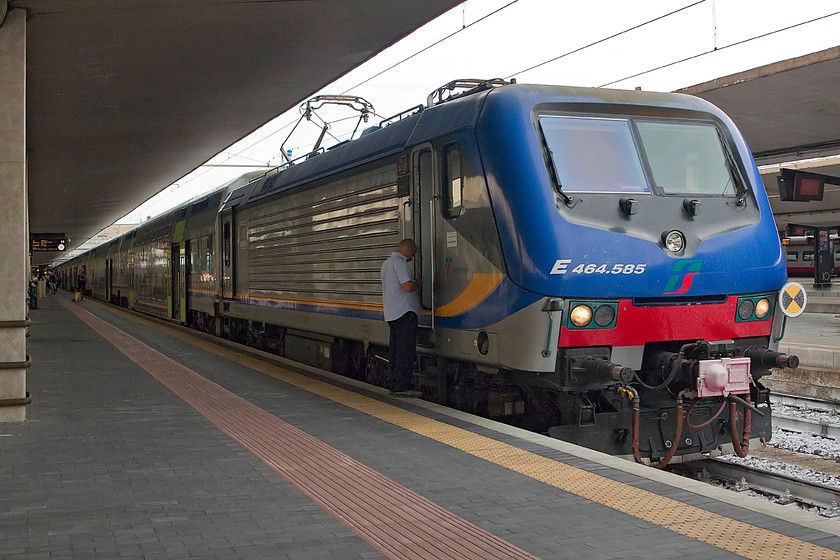 464.585, 17.35 Florence SMN-Chiusi CT (3099), Florence SMN station 
 464.585's driver attends to his 'phone before preparing his train for the 17.35 to Chiusi Chianciano Terme. It is waiting at Floremcce SMN's platform 14 and will be packed with commuters making their way home. This member of the class 464 is one of the modified examples that can operate the relatively new double-decker stock. 
 Keywords: 464.585 17.35 Florence SMN-Chiusi CT 3099 Florence SMN station