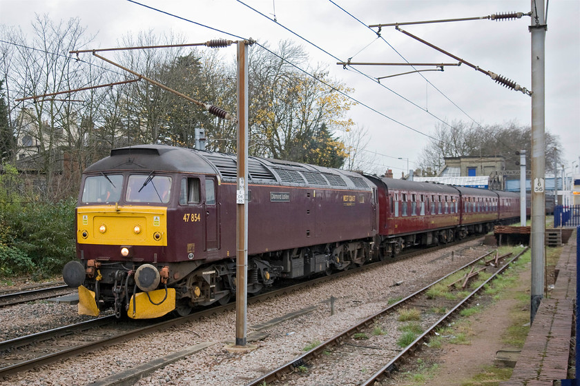 47854, 00.05 Carnforth-London King's Cross ECS (5Z45), Hornsey station 
 Having made its way gingerly down the relief line at Hornsey station the stock for The Lindum Fayre charter prepares to be led the short distance into King's Cross. The stock has travelled to London overnight as the 00.05 from Carnforth with 46233 'Duchess of Sutherland' joining the train after running in light engine from West Coast's Southall facility. 
 Keywords: 47854 00.05 Carnforth-London KIng's Cross ECS 5Z45 Hornsey station Diamond Jubilee