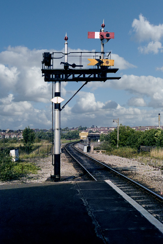 Up starter bracket signal, Frome station 
 I called in at Frome station on my way to Blatchbridge Junction. At this stage in its life, the historic Brunel broad-gauge station was in a pretty shocking state of disrepair held up by scaffolding to prevent its total collapse! At the platform end, the up starter bracket is seen in the afternoon sun. The bare doll once had a home starter signal arm for the bay platform from where trains left for Radstock. The other post has two centre pivot wooden arms that were very rare, even in 1978! It now resides at the National Railway Museum at York. This signal was controlled by Frome North signal box situated a short distance up the line behind the stabled Foster Yeoman wagons. I took a further photograph of this amazing piece of infrastructure during a visit two years subsequently, see.... https://www.ontheupfast.com/p/21936chg/25473984004/up-starter-bracket-signal-frome 
 Keywords: Up starter bracket signal Frome station