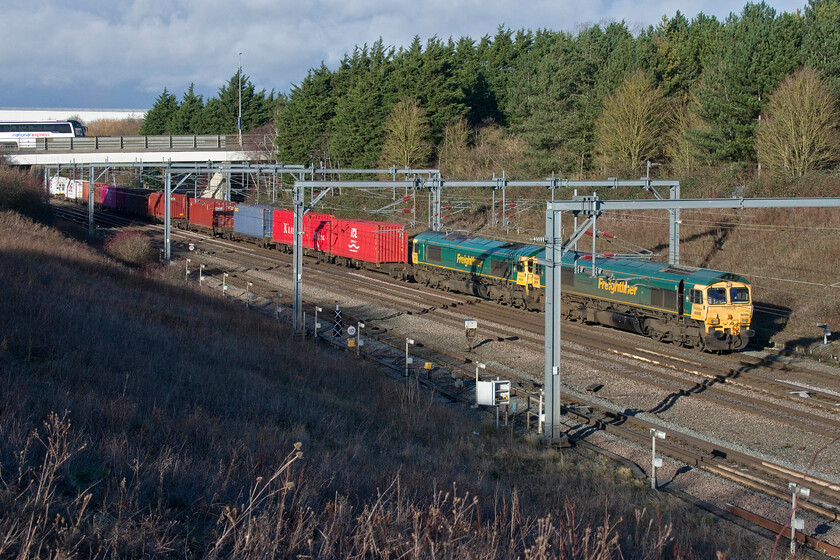 66506 & 66554, 10.00 Crewe BasfordHall-Southampton MCT (4O35, 2L), Loughton Redway bridge, Milton Keynes 
 Unfortunately, the locomotives of an unexpected double-headed 10.00 Crewe Basford Hall to Southampton Freightliner service did not quite fit between the electrification masts just north of Milton Keynes station. This train is normally headed by a Class 70 but today 66506 'Crewe Regeneration' and 66554 look good in some extremely welcome winter sunshine. 
 Keywords: 66506 66554 10.00 Crewe BasfordHall-Southampton MCT 4O35 Loughton Redway bridge Milton Keynes Crewe Regeneration